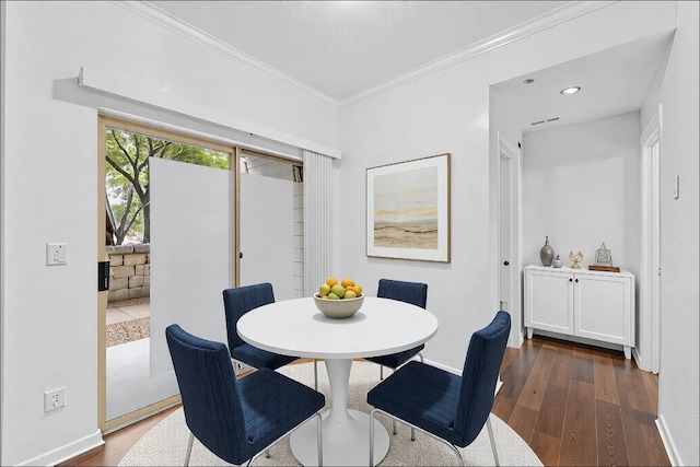 dining space featuring baseboards, ornamental molding, and dark wood-style flooring