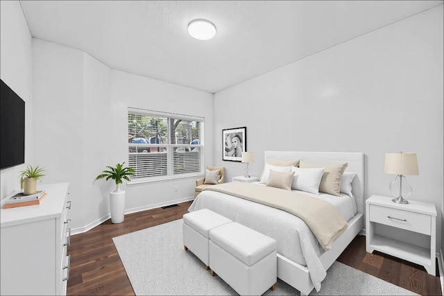 bedroom featuring baseboards, visible vents, and dark wood-style flooring