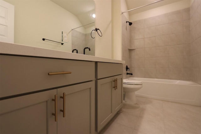 bathroom featuring shower / bath combination, toilet, vanity, and tile patterned flooring