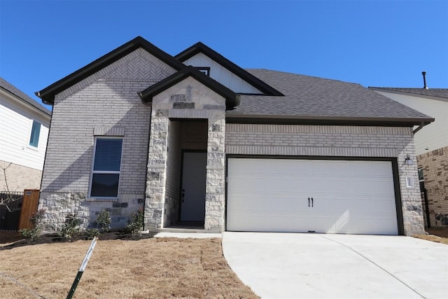 view of front of house with an attached garage, brick siding, stone siding, and driveway