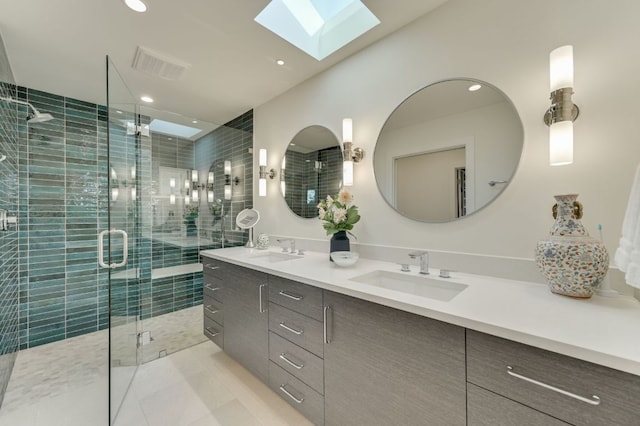 bathroom with double vanity, a stall shower, visible vents, and a sink