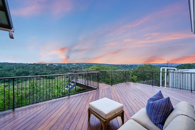 wooden deck featuring a view of trees