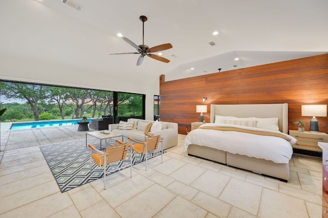 bedroom featuring visible vents, high vaulted ceiling, wood walls, and access to exterior