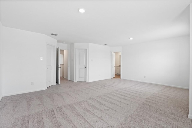 carpeted empty room with recessed lighting, visible vents, and baseboards