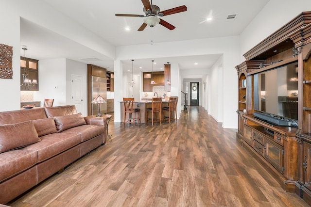 living room featuring dark wood-type flooring, recessed lighting, visible vents, and a ceiling fan