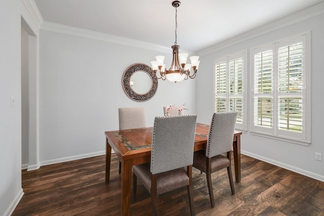 dining space featuring baseboards, a chandelier, dark wood finished floors, and crown molding