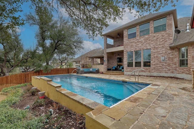 view of pool featuring a patio, an outdoor living space, a fenced backyard, and a fenced in pool