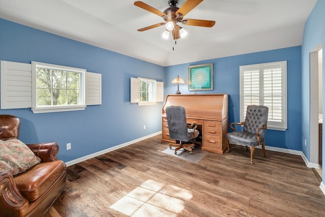 office space with ceiling fan, baseboards, vaulted ceiling, and wood finished floors