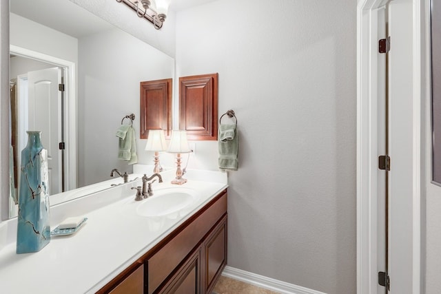 bathroom featuring baseboards and vanity