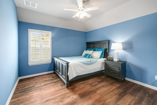 bedroom featuring baseboards, visible vents, ceiling fan, and wood finished floors