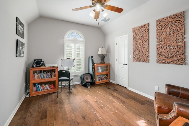 living area with visible vents, baseboards, a ceiling fan, lofted ceiling, and hardwood / wood-style flooring