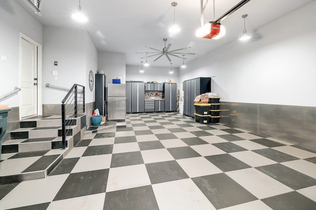 kitchen featuring freestanding refrigerator, pendant lighting, and light floors