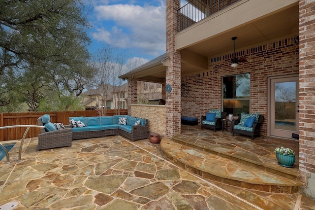 view of patio / terrace with a balcony, fence, an outdoor living space, and area for grilling