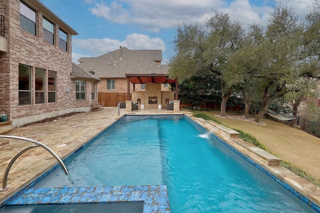 view of pool featuring a lawn, a fenced in pool, a fenced backyard, an outdoor fireplace, and a patio area