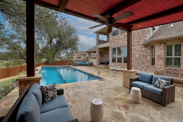 view of pool featuring a fenced in pool, a patio, a ceiling fan, a fenced backyard, and an outdoor living space