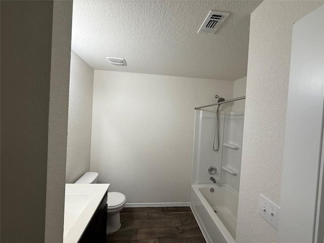 full bath with visible vents, toilet, wood finished floors, a textured ceiling, and vanity