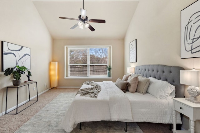 carpeted bedroom with vaulted ceiling, baseboards, and ceiling fan