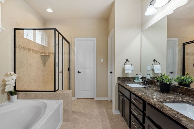 bathroom featuring a garden tub, a sink, a shower stall, tile patterned floors, and double vanity