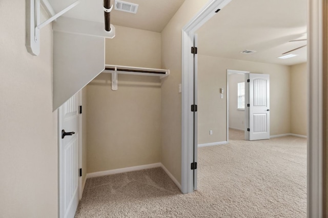 walk in closet featuring carpet floors and visible vents