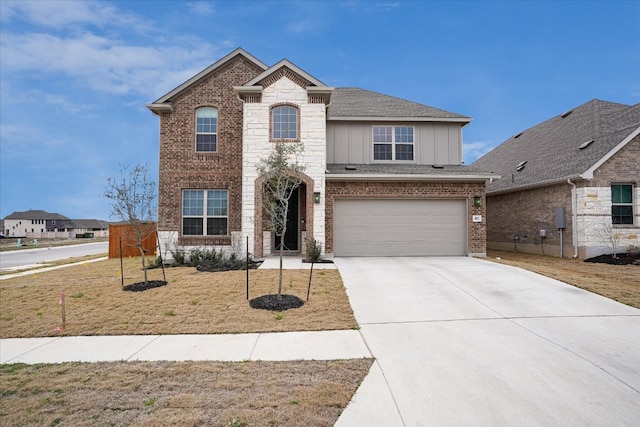 view of front of home with an attached garage, brick siding, concrete driveway, a front lawn, and board and batten siding