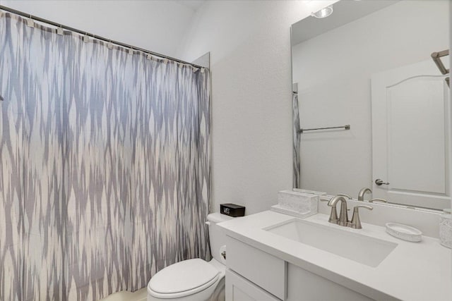 bathroom with a shower with shower curtain, vanity, and toilet