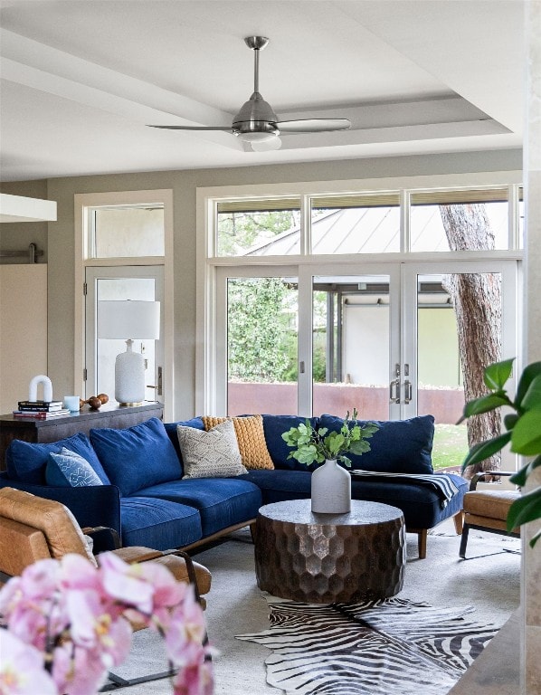 sunroom / solarium with a ceiling fan and french doors