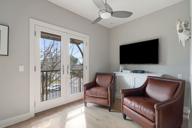 living area with ceiling fan, french doors, light wood-style flooring, and baseboards