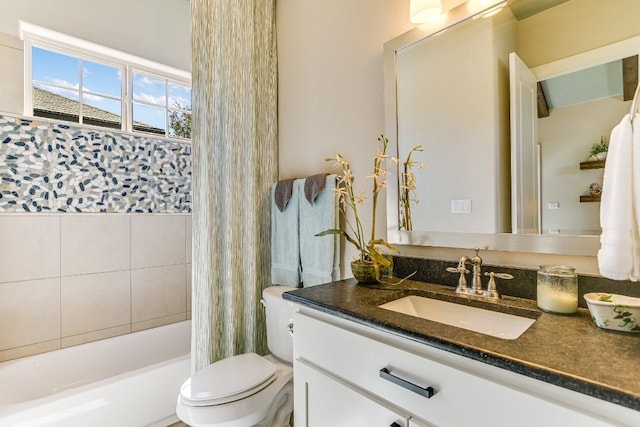 bathroom featuring shower / bath combo with shower curtain, vanity, and toilet