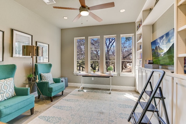 living area featuring ceiling fan, baseboards, and recessed lighting