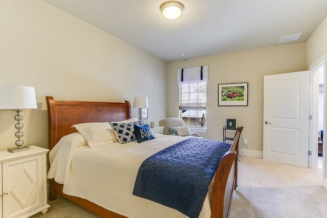 bedroom with carpet, visible vents, and baseboards