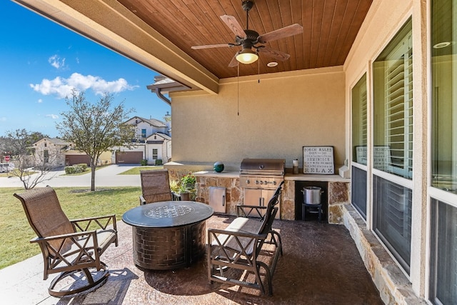 view of patio / terrace with ceiling fan, a fire pit, and area for grilling