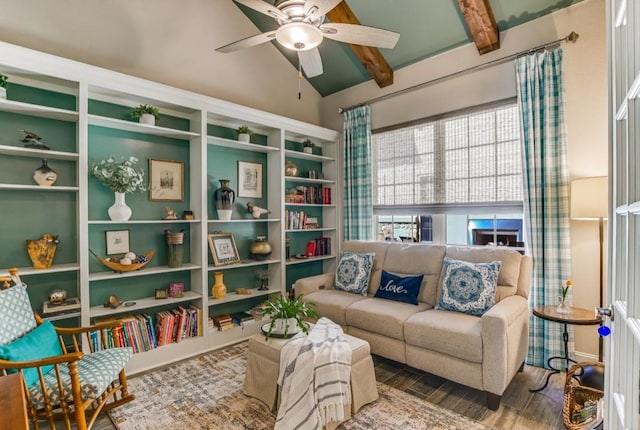 sitting room with a ceiling fan, vaulted ceiling with beams, and wood finished floors