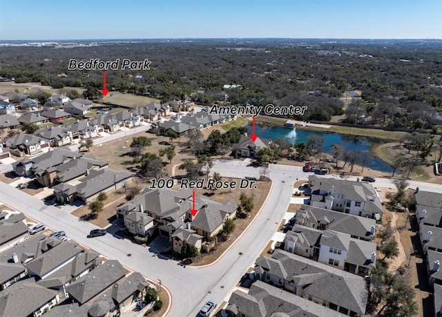 birds eye view of property with a residential view and a water view