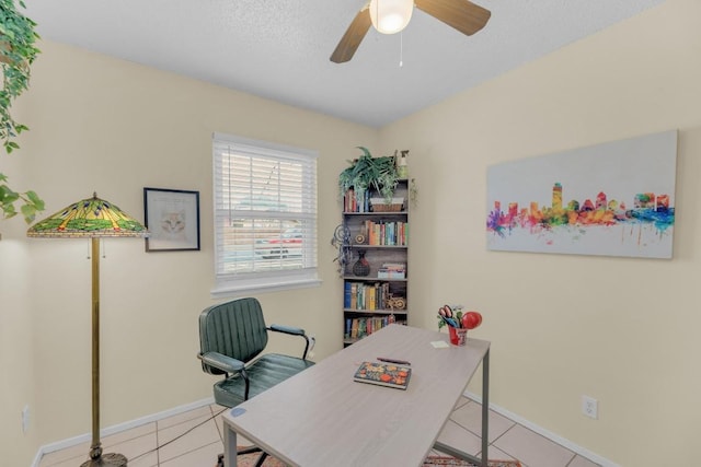 office with a ceiling fan, baseboards, and tile patterned floors