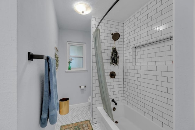 bathroom with shower / tub combo, baseboards, tile patterned flooring, and toilet