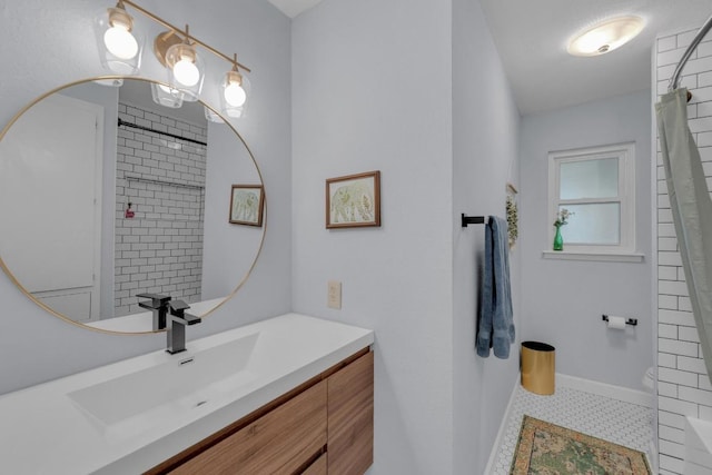 bathroom featuring toilet, baseboards, vanity, and a shower with curtain