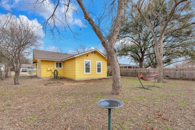 view of side of home featuring fence