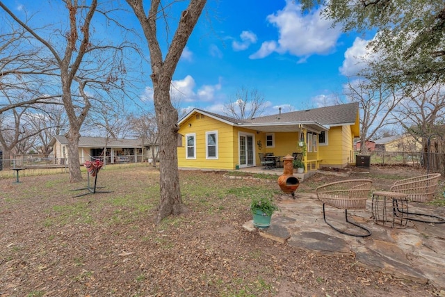 back of property featuring a patio and fence