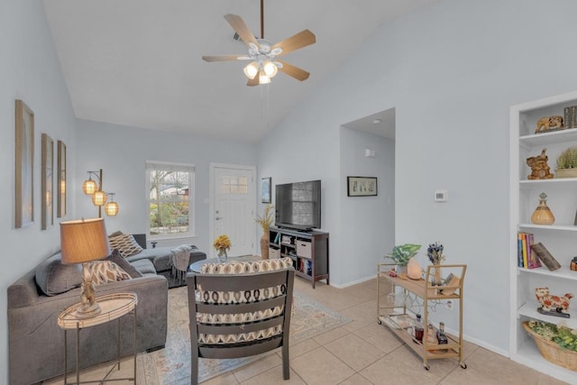 living area with light tile patterned floors, high vaulted ceiling, a ceiling fan, and baseboards