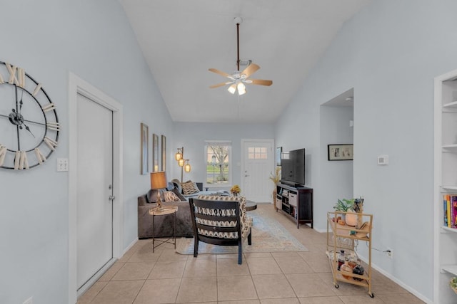 living room with light tile patterned floors, ceiling fan, lofted ceiling, and baseboards