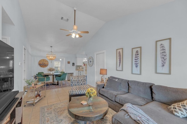 living area featuring lofted ceiling, visible vents, a ceiling fan, and light tile patterned flooring