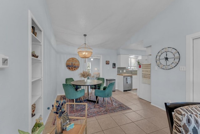 dining space with lofted ceiling, light tile patterned floors, and built in shelves