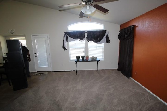 spare room with carpet floors, vaulted ceiling, and a ceiling fan