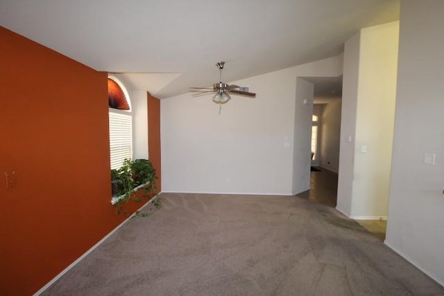 carpeted empty room featuring ceiling fan