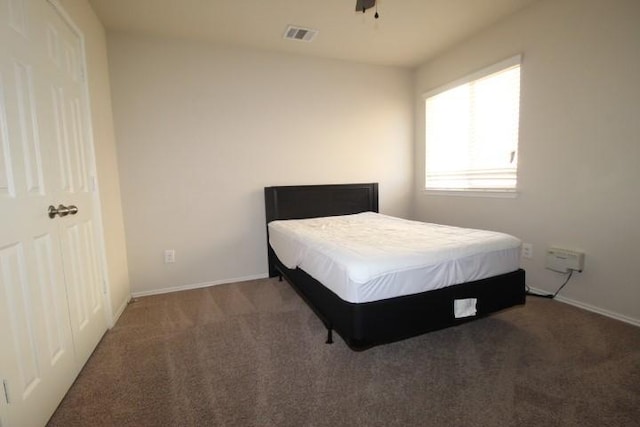 bedroom with carpet floors, baseboards, and visible vents