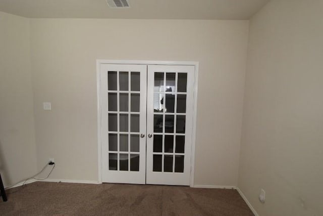 doorway with carpet floors, french doors, visible vents, and baseboards