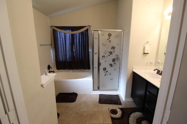 bathroom featuring lofted ceiling, a garden tub, tile patterned flooring, vanity, and a shower stall