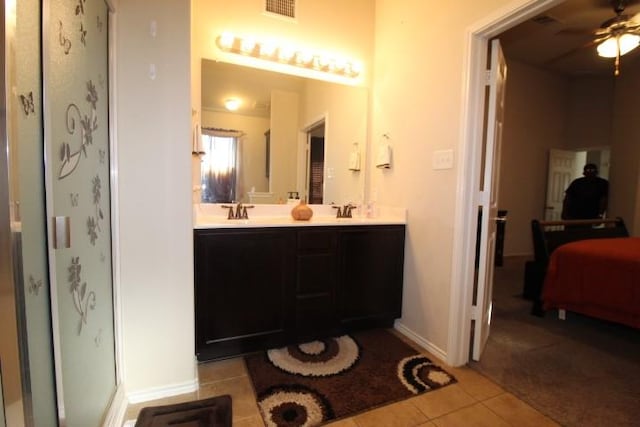 bathroom with a sink, a shower with shower door, tile patterned flooring, and visible vents