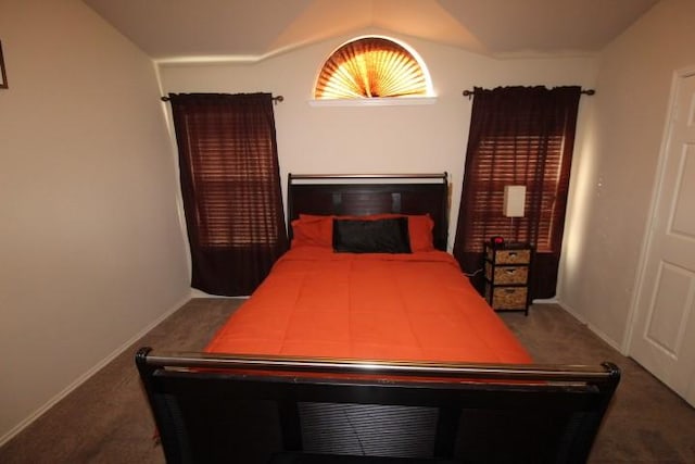 carpeted bedroom with baseboards and vaulted ceiling