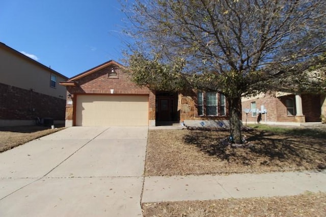 ranch-style house featuring a garage, brick siding, and driveway